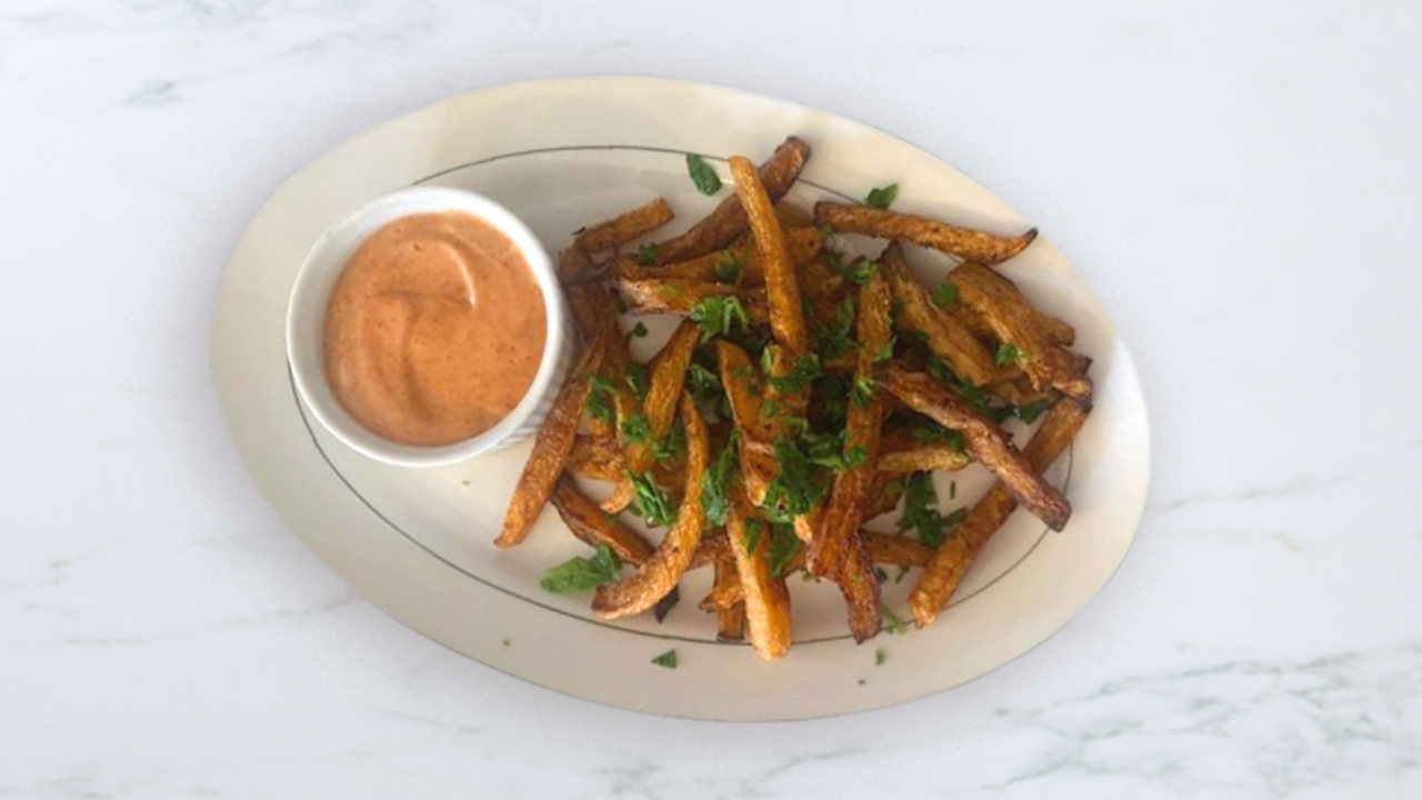 Plate of rutabaga fries with a side of sauce