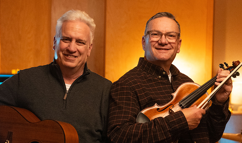 Mike and Tom holding instruments