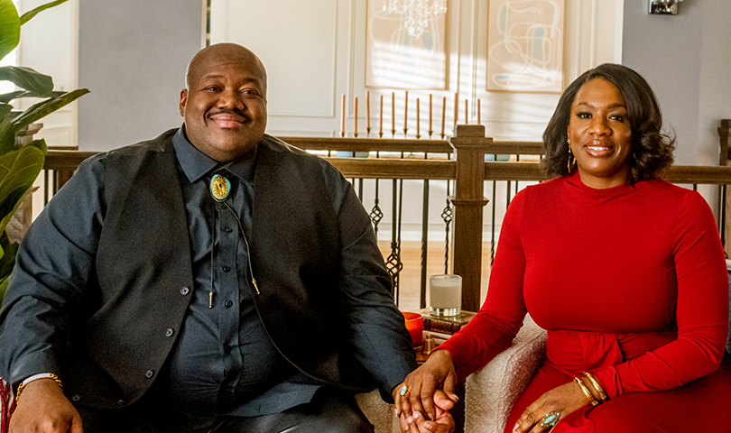 Michael and Tanya smiling and holding hands